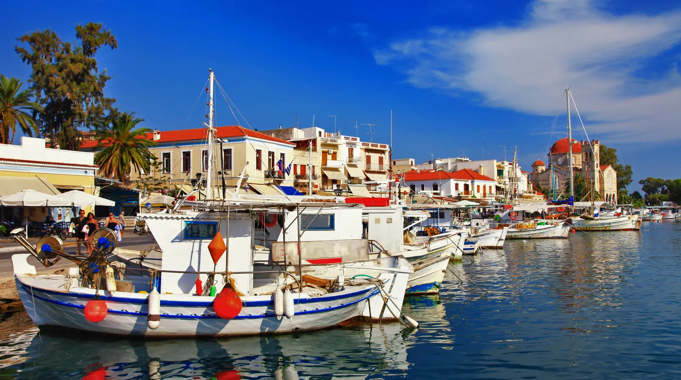 Fishing boats moored along the harbour front of Aegina town