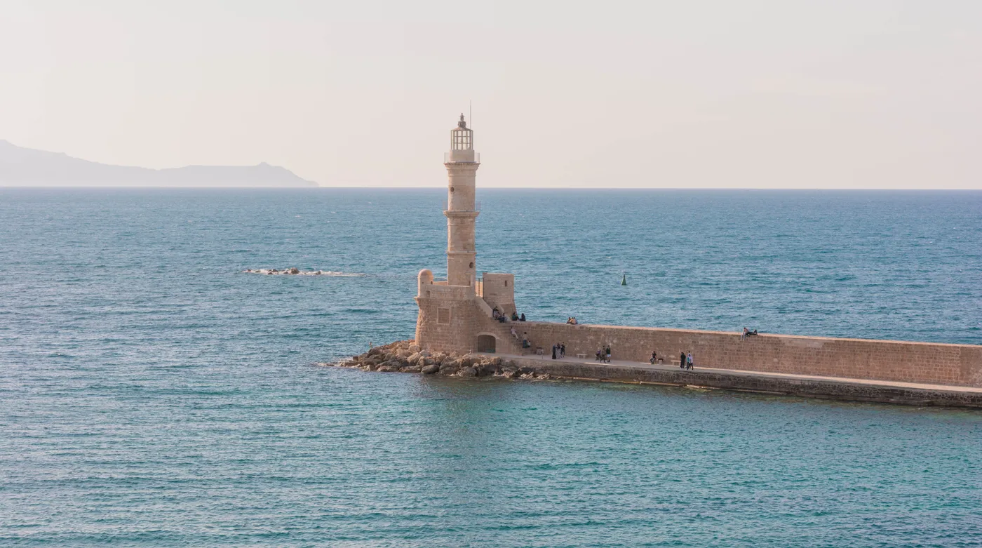 The Venetian lighthouse at the mouth of the Chania harbour, late light on the sea wall