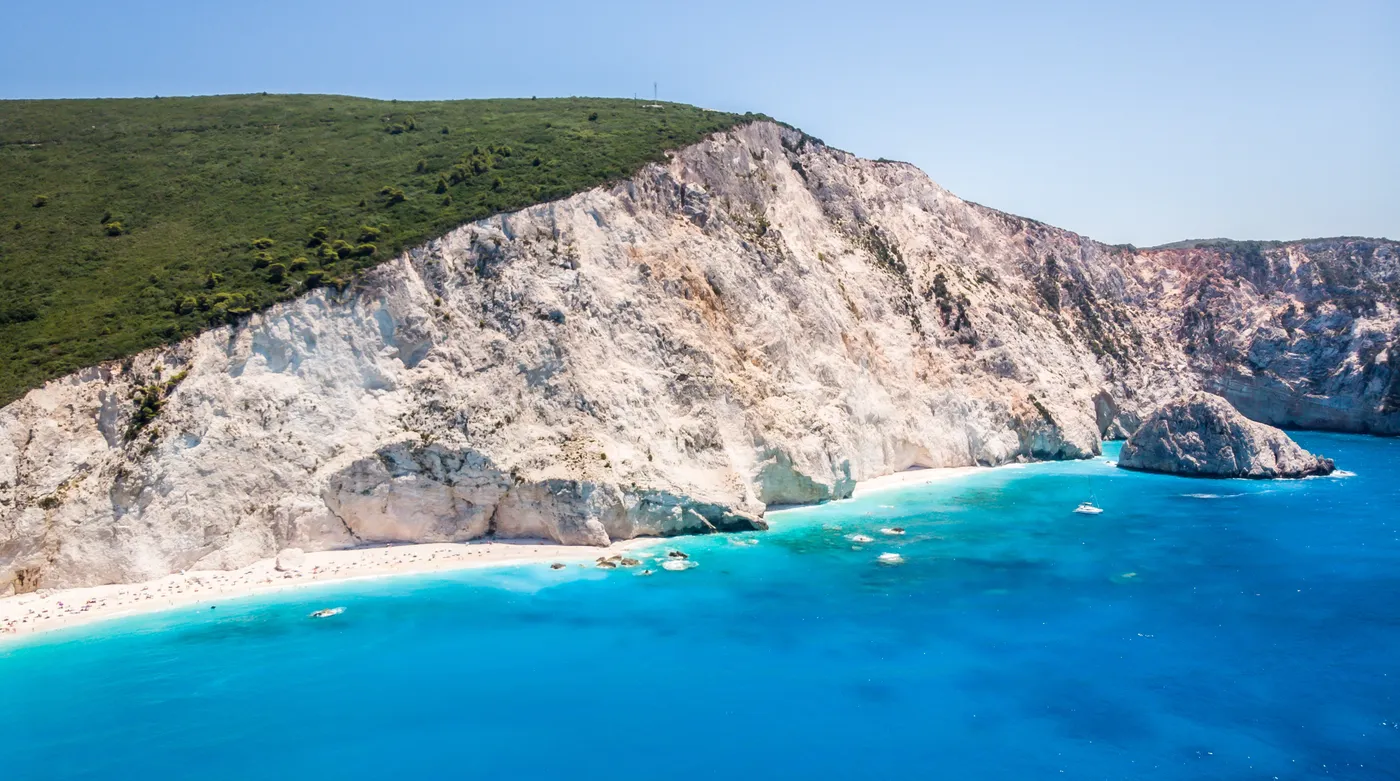 White cliffs falling to a long pale beach and turquoise water on the west coast of Lefkada