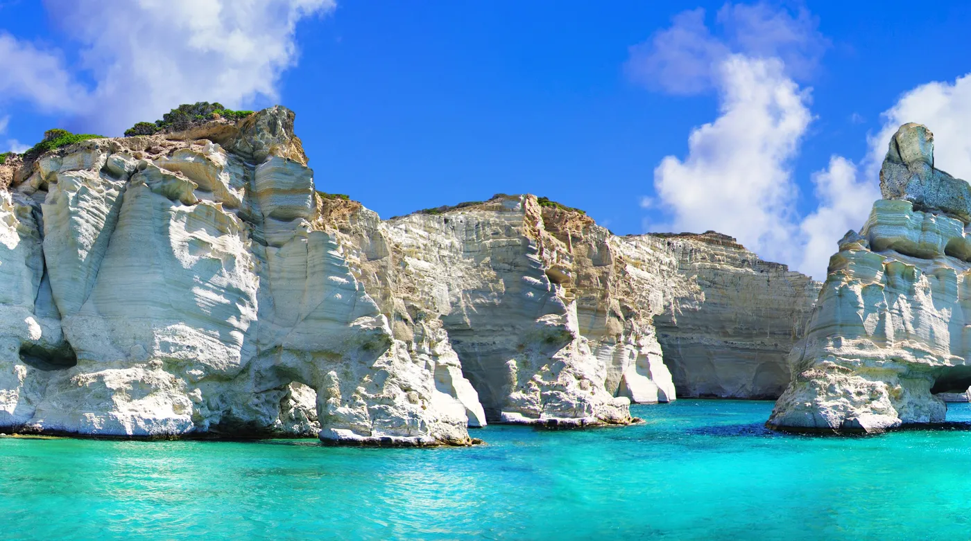 The white rock of Kleftiko on Milos rising from turquoise water, reached only by boat