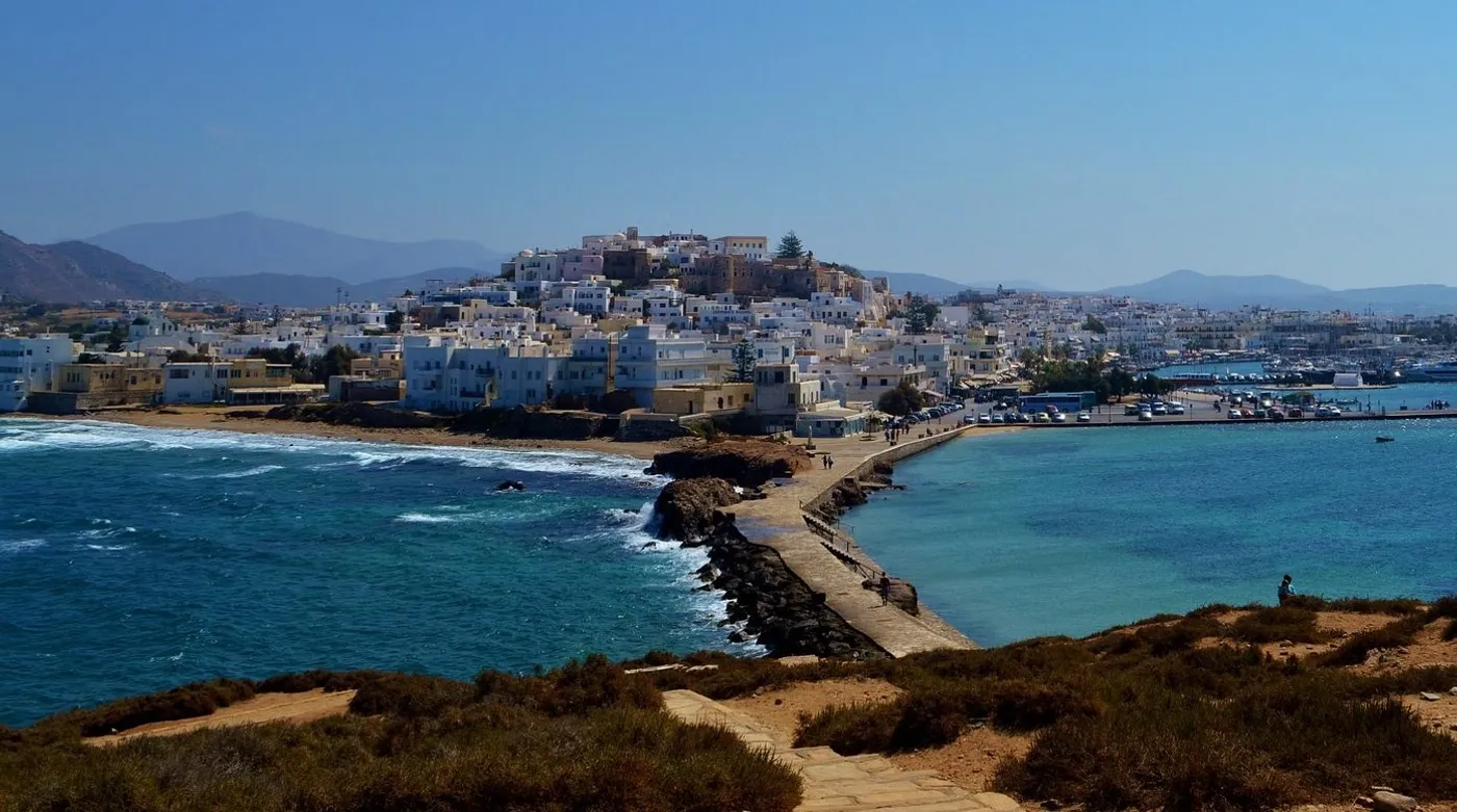 Naxos Town spread along its waterfront, the causeway running out towards the Portara