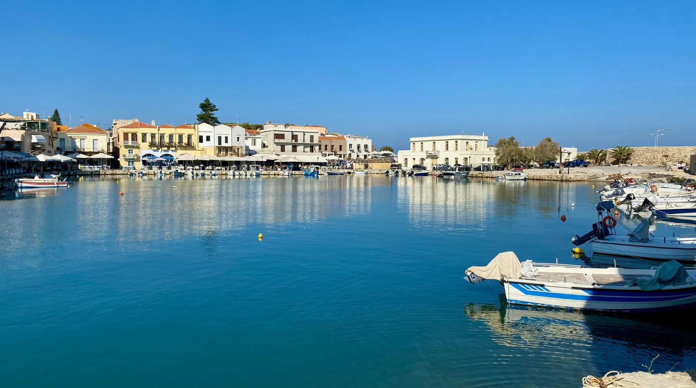 The old Venetian harbour of Rethymno, fishing boats on still morning water