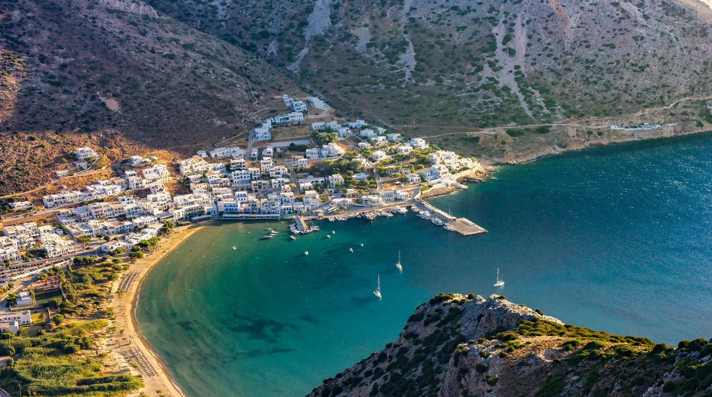The harbour village of Kamares on Sifnos, curled around its bay below bare hills