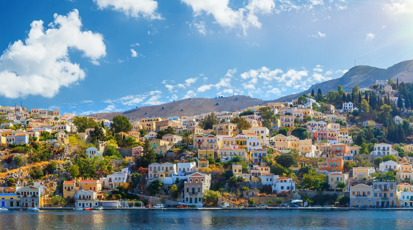 The tiers of ochre and rose houses around the harbour of Symi