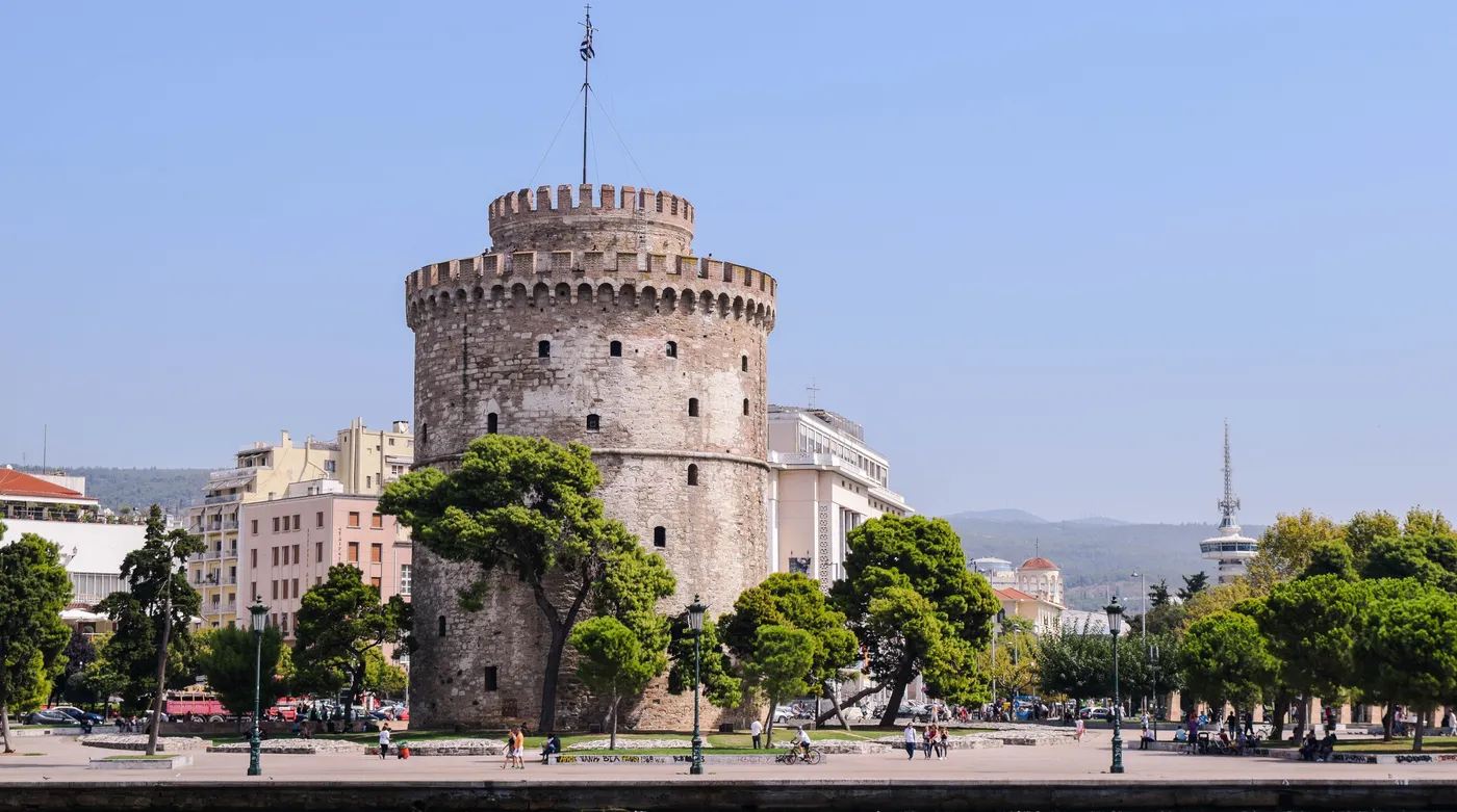 The White Tower of Thessaloniki above the waterfront trees