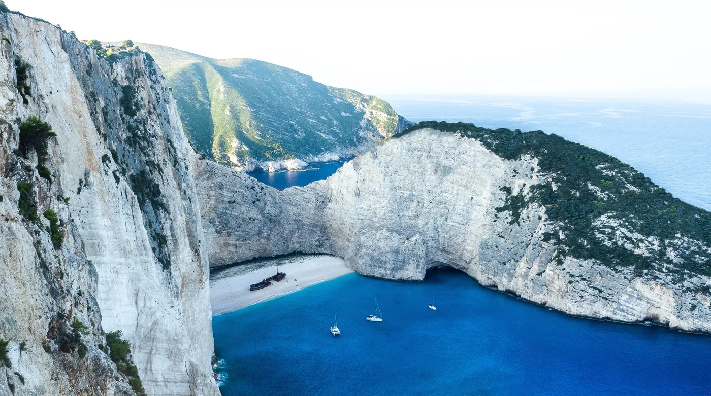 The wreck on Navagio beach on Zakynthos from the cliff rim, white sand and ultramarine water