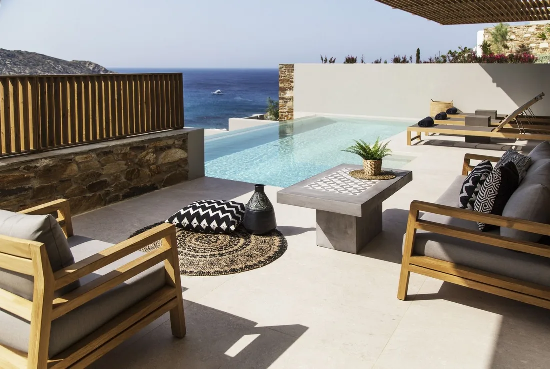 A private infinity pool on a hillside terrace, the sea beyond